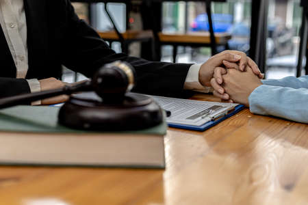 Lawyers shake hands to encourage clients who come to join the case of embezzlement from business...