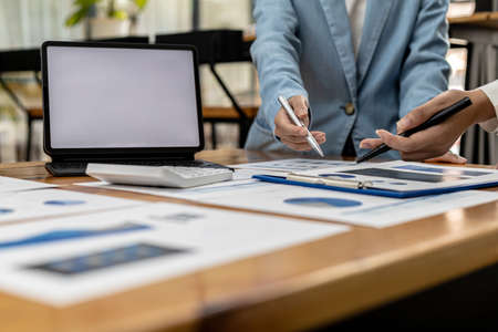 Meeting room atmosphere, business people meeting together on finance topics, they are working together to plan and solve corporate finance issues. Concept of business administration and finance.の写真素材