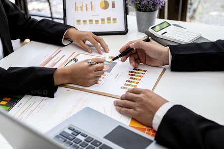 The sales department is having a monthly summary meeting to bring it to the department manager, they are verifying the correctness of the documents that are prepared before bringing in to the managerの写真素材