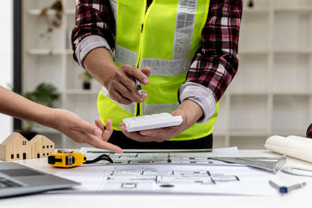 Two architect-engineers are consulting to modify the blueprints of the contracted house, they have a...