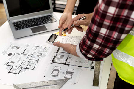 Two architect-engineers are consulting to modify the blueprints of the contracted house, they have a meeting to inspect the house designs before meeting with the client. Home design ideas.の写真素材