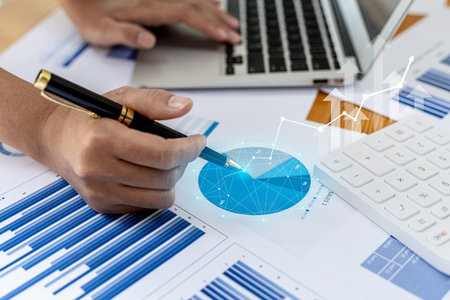 A business man examines data on financial documents, company financial reports, graphics showing...