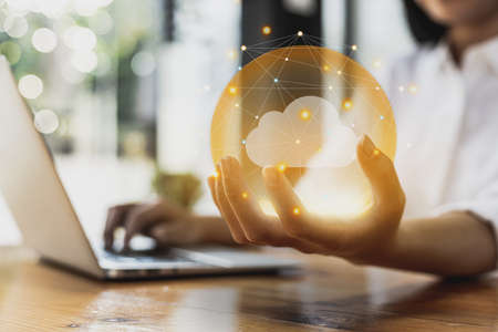 Glowing circle on human hand with connecting lines around it and cloud image inside, cloud storage service concept, data safe keeping, data connection from anywhere, Connect a variety of information.の写真素材