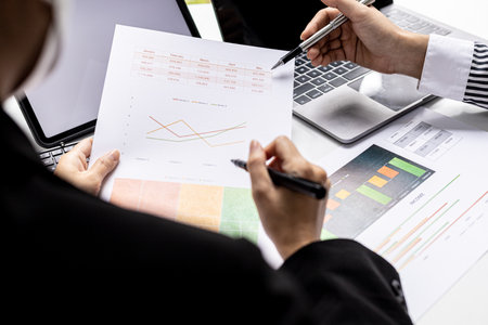 The sales department is having a monthly summary meeting to bring it to the department manager, they are verifying the correctness of the documents that are prepared before bringing in to the managerの写真素材