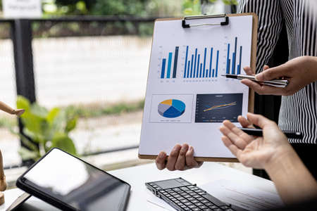 Atmosphere in the meeting room of a startup, the Chief Financial Officer is presenting the company's financial summary to the executives. Concept of financial management of startup companies.の写真素材