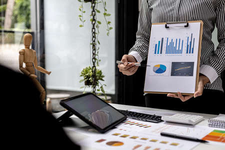 Atmosphere in the meeting room of a startup, the Chief Financial Officer is presenting the company's financial summary to the executives. Concept of financial management of startup companies.の写真素材