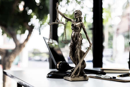 Lawyer's Desk On the table is a statue of Themis who is the goddess of justice and the hammer of...