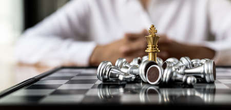 Close-up of chess pieces placed on a chessboard, concept comparing chessboard play to business operations, strategic planning and analysis of business competitors to win and grow.の写真素材