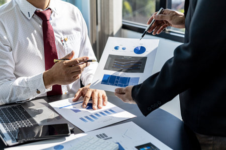 The sales department is having a monthly summary meeting to bring it to the department manager, they are verifying the correctness of the documents that are prepared before bringing in to the managerの写真素材