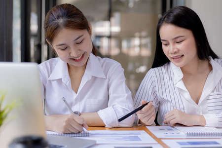 Finance managers and employees are meeting in a conference room, on the table there are some documents about the company's finances, managers are discussing financial information with the management.の写真素材