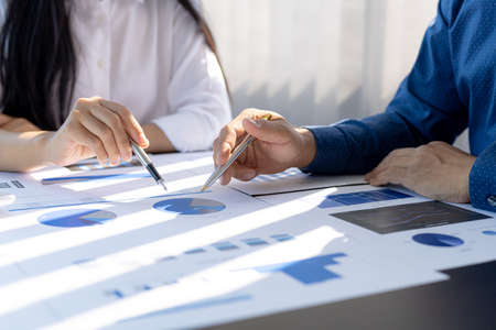 The sales department is having a monthly summary meeting to bring it to the department manager, they are verifying the correctness of the documents that are prepared before bringing in to the managerの写真素材
