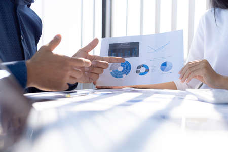 The sales department is having a monthly summary meeting to bring it to the department manager, they are verifying the correctness of the documents that are prepared before bringing in to the managerの写真素材