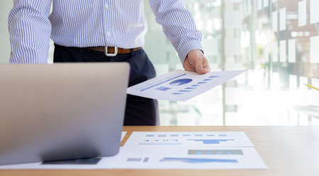 A business men working in a private room, He is typing on a laptop keyboard, He uses a messenger to...