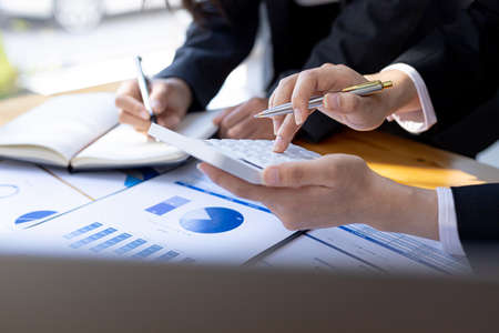 Executives and managers are meeting in a conference room, on the table there are some documents...