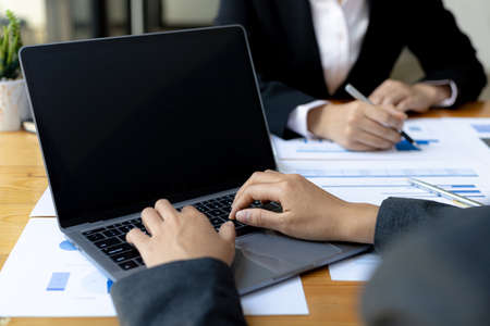 Two businessmen are meeting together in the office, they are meeting on the topic of finance and financial management, they are business partners. Concept of financial management for startup companiesの写真素材