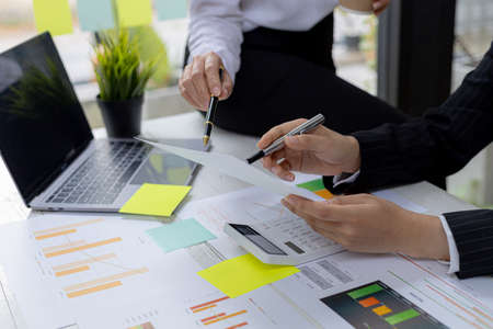 The atmosphere in the meeting room where the businessmen are meeting, information papers and charts...