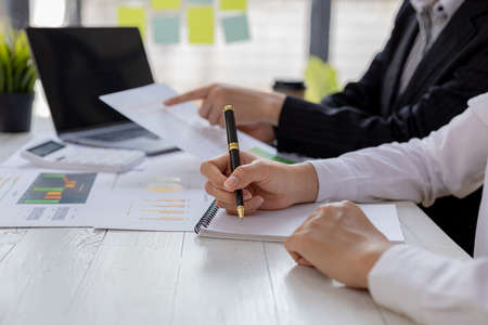 Atmosphere brainstorming session of a startup company, two founders of the company attended a meeting to plan the management and financial growth of the company. Management startup company concept.の写真素材