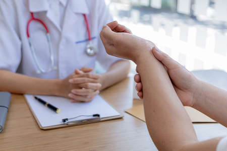 An examination room atmosphere in a hospital where doctors and patients are examining and diagnosing and prescribing medications for symptomatic treatment. The concept of disease diagnosis.の写真素材