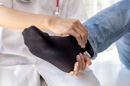 Physiotherapist is doing physical therapy for a patient, the patient has body aches due to overwork and has undergone treatment and physiotherapy with a professional physiotherapist.の写真素材