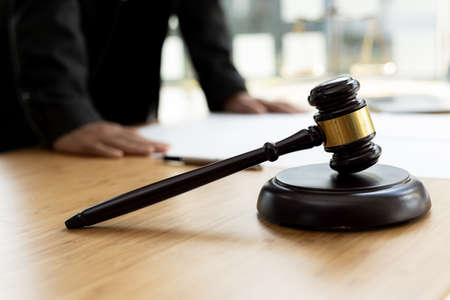 The judge's hammer is placed on the table, the lawyer concept assumes that the defendant defends the...