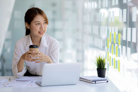 Beautiful Asian woman is a businesswoman who leads a new generation of startups, a woman who runs and manages a business plan to build confidence and stability in business, woman-led business concept.の写真素材