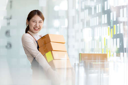 Woman owner of a startup company selling products online on an online store platform, sending goods...