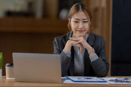 Beautiful Asian woman is a businesswoman who leads a new generation of startups, a woman who runs and manages a business plan to build confidence and stability in business, woman-led business concept.の写真素材