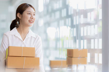 Woman owner of a startup company selling products online on an online store platform, sending goods...