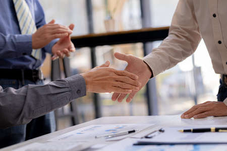 Business investor group holding hands, Two businessmen are agreeing on business together and shaking...