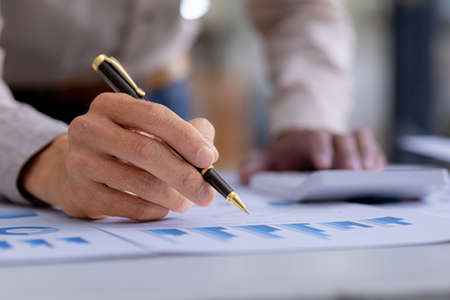 Business men are looking at the company's financial documents to analyze problems and find solutions...