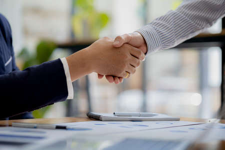 Close-up two business men holding hands, Two businessmen are agreeing on business together and...