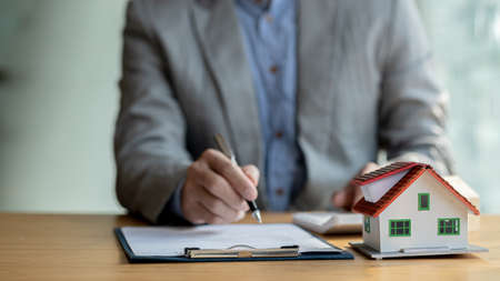The salesperson of the housing estate in the project is preparing and verifying the contract of sale...