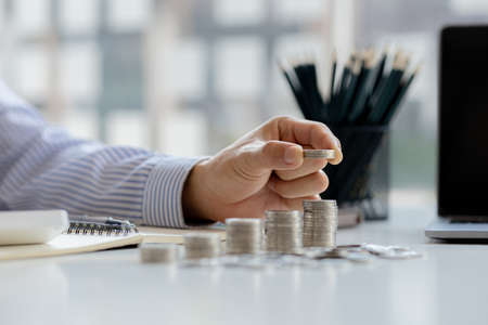 Stacks of coins arranged in a row from low to high, analogous to the growth of money, investing in stocks, stock market chart graphics showing stock trading. The idea of investing money.の写真素材