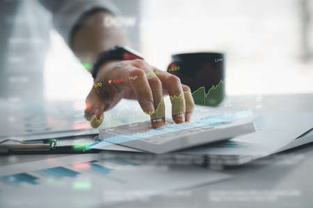 The person is calculating, business analysis, stock market report, technology concept. Finance analyst, stock trader analysing business data, financial graph on digital smart phone. Investment conceptの写真素材