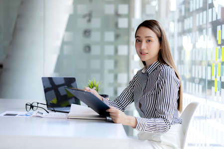 Beautiful Asian woman is a businesswoman who leads a new generation of startups, a woman who runs...