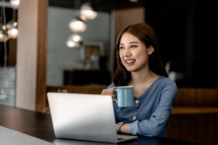 Beautiful Asian woman is a businesswoman who leads a new generation of startups, a woman who runs and manages a business plan to build confidence and stability in business, woman-led business concept.の写真素材