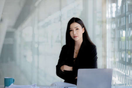 Asian women sitting in the office, young Asian business women as business executives, founding and running start-up executives, young female business leaders. Startup business concept.の写真素材