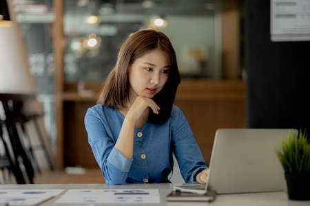 Asian women sitting in the office, young Asian business women as business executives, founding and running start-up executives, young female business leaders. Startup business concept.の写真素材