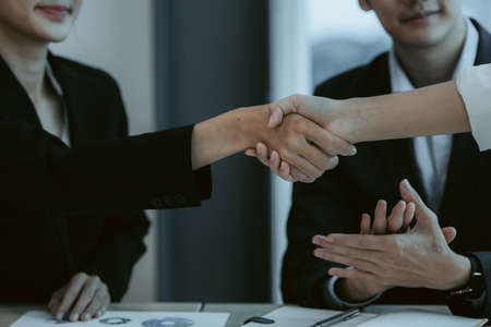 Business dealings and handshakes, startup company marketing team meetings, brainstorming sessions for implementation planning, management by new generations. The idea of opening a startup company.の写真素材