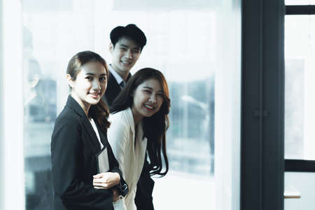 A group of business men and women in the office of a company, business partners forming a startup company and working together to manage and operate the company to grow. Company management concept.の写真素材