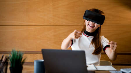 Woman wearing virtual reality glasses to use the technology of the future, using virtual reality...