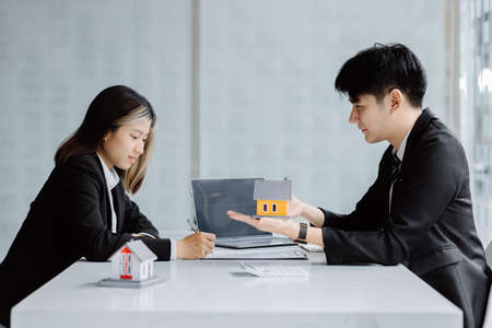 Rental company employee is discussing the details before the customer agrees to sign a rental...