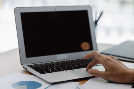 Close-up of hands resting on keyboard to view financial data, business growth in the world of cryptocurrencies and the current global economy with war and volatility. Finance and investment concepts.の写真素材