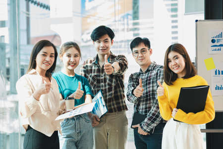 A group of startup employees are coming together for planning meetings and brainstorming solutions to problems in the company, they are young people with talent and vision. Management concept.の写真素材