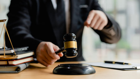 A person holding the hammer of justice, the concept of a lawyer or a law enforcement officer is...