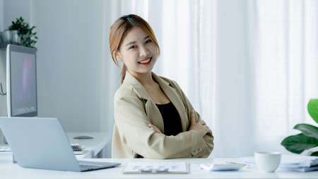Asian women working in the office, young Asian business women as business executives, founding and running start-up executives, young female business leaders. Startup business concept.の写真素材