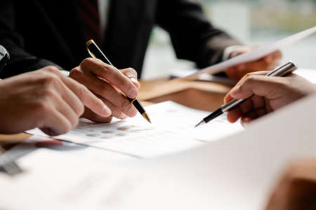 Business man group are meeting together in the office, they are meeting on the topic of finance and...