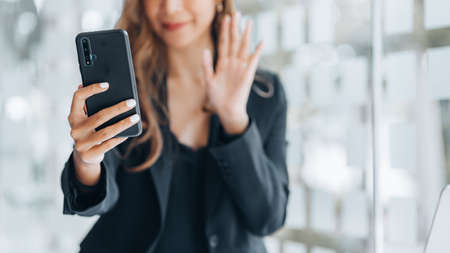 Business Woman with business partner via video call on smartphone, she is meeting with partner on...