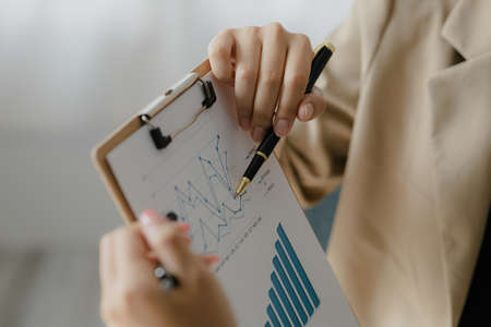 Two Asian business women are meeting to summarize the company's operating, financial, profit and loss results. Management of startup companies. Profitable management concept and growing management.の写真素材