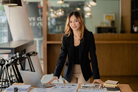 Portrait of a young beautiful Asian woman in a office room, concept image of Asian business woman, modern female executive, startup business woman, business leader woman.の写真素材